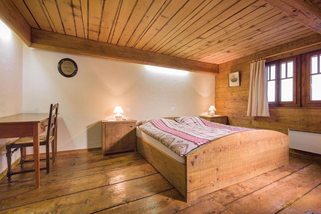um quarto com uma cama e um tecto de madeira em Mayen2003 Ayent Anzère em Ayent