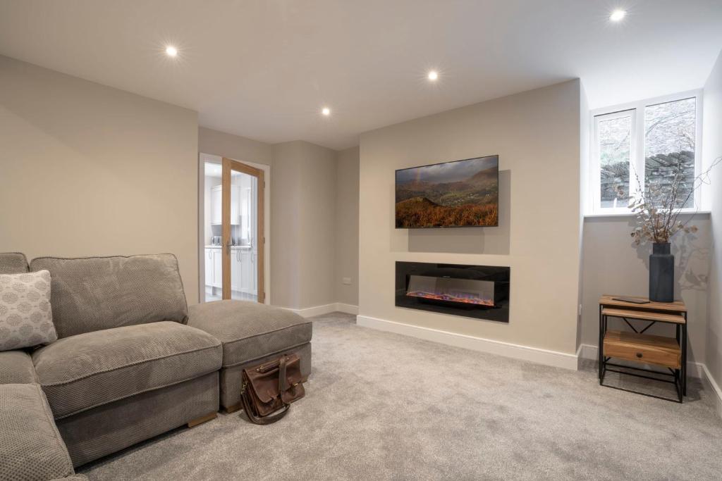 a living room with a couch and a fireplace at The Hideaway with Cosy Fireplace by LetMeStay in Ambleside