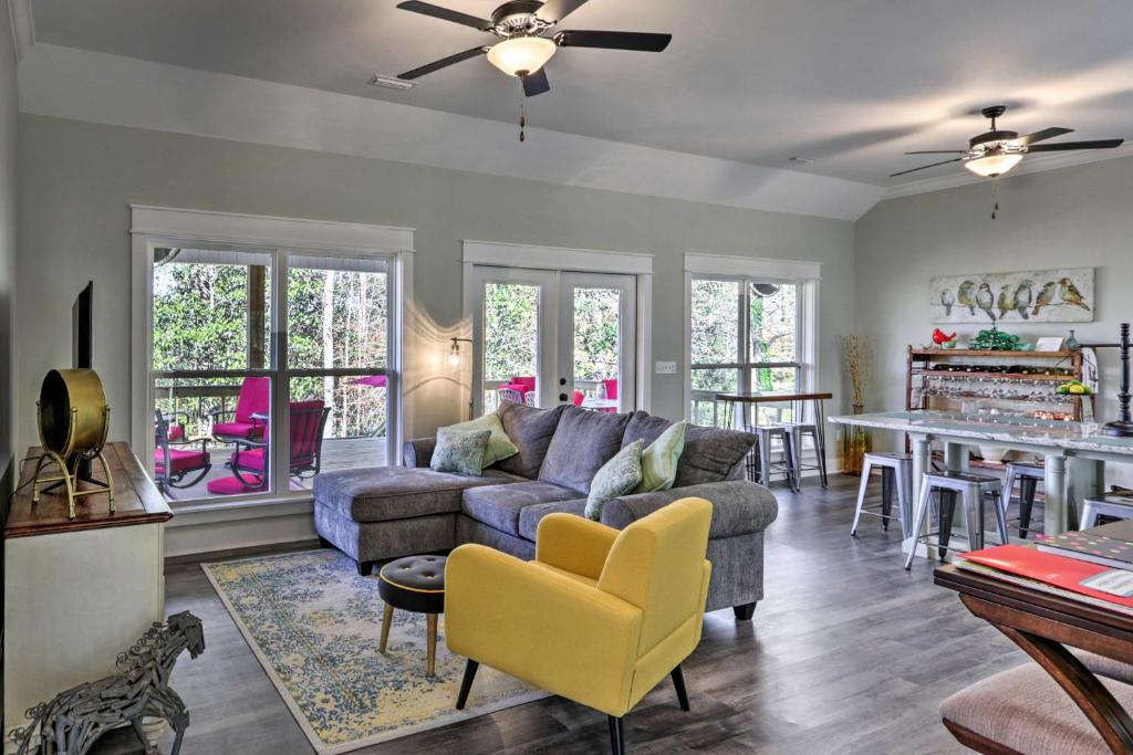 a living room with a couch and a table at White Oak Creek Home with Views, Deck and Pool Access! in Eufaula