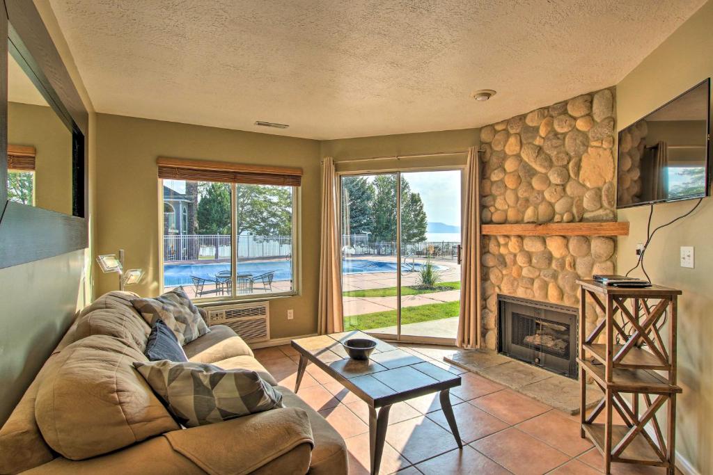 a living room with a couch and a fireplace at Garden City Condo with Pool Access by Bear Lake! in Garden City