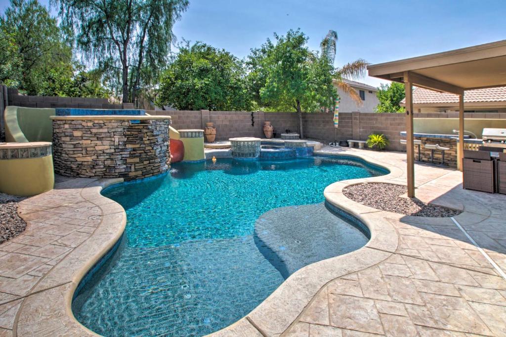 a swimming pool in the backyard of a house at Modern Phoenix Haven with Private Pool and Patio! in Phoenix