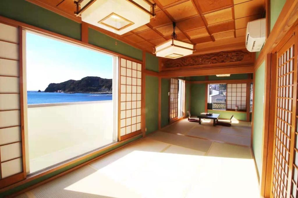 a room with a view of the ocean from a room with windows at Kamogawa Shokudo - Vacation STAY 15119v in Kamogawa