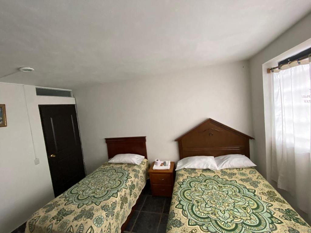 Postel nebo postele na pokoji v ubytování Hotel Posada de Belen
