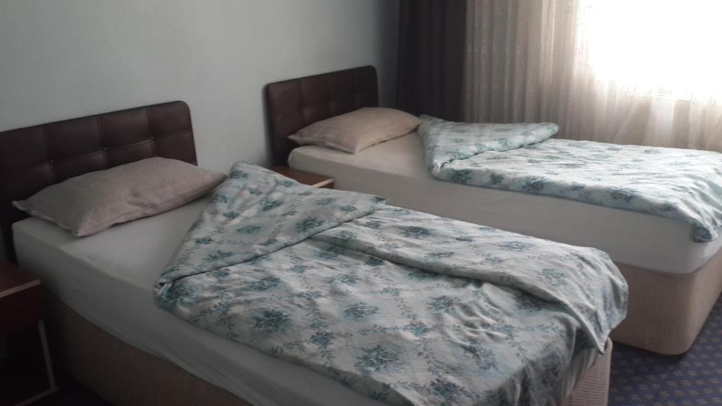 Postel nebo postele na pokoji v ubytování Esin Pansiyon
