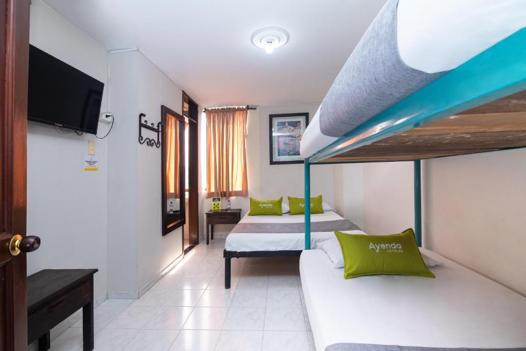 Postel nebo postele na pokoji v ubytování Hotel Ayenda Calypso 1142