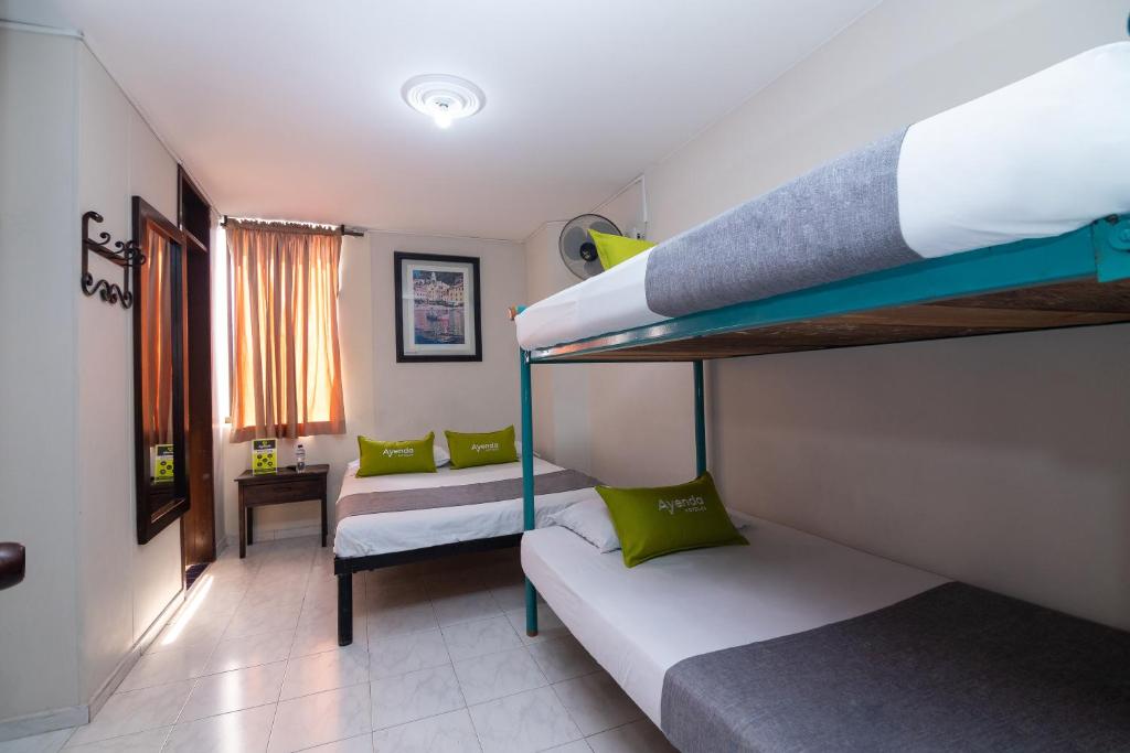 Postel nebo postele na pokoji v ubytování Hotel Ayenda Calypso 1142