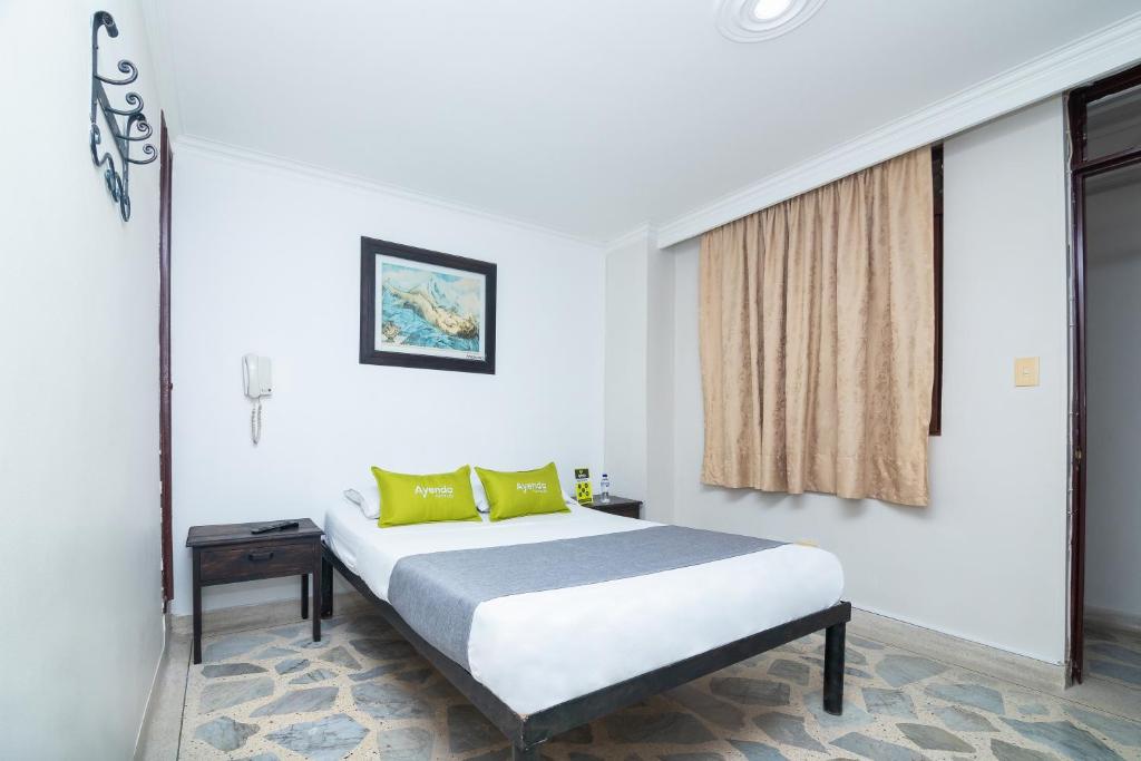 Postel nebo postele na pokoji v ubytování Hotel Ayenda Calypso 1142