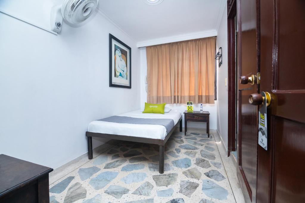 Postel nebo postele na pokoji v ubytování Hotel Ayenda Calypso 1142