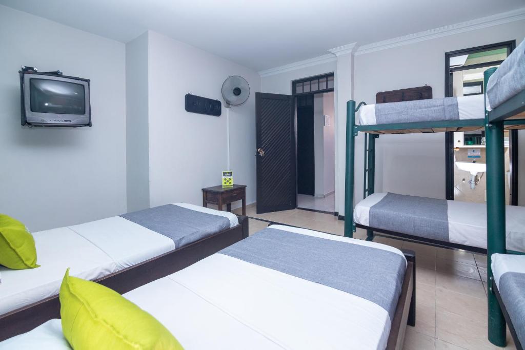 Postel nebo postele na pokoji v ubytování Hotel Ayenda Calypso 1142