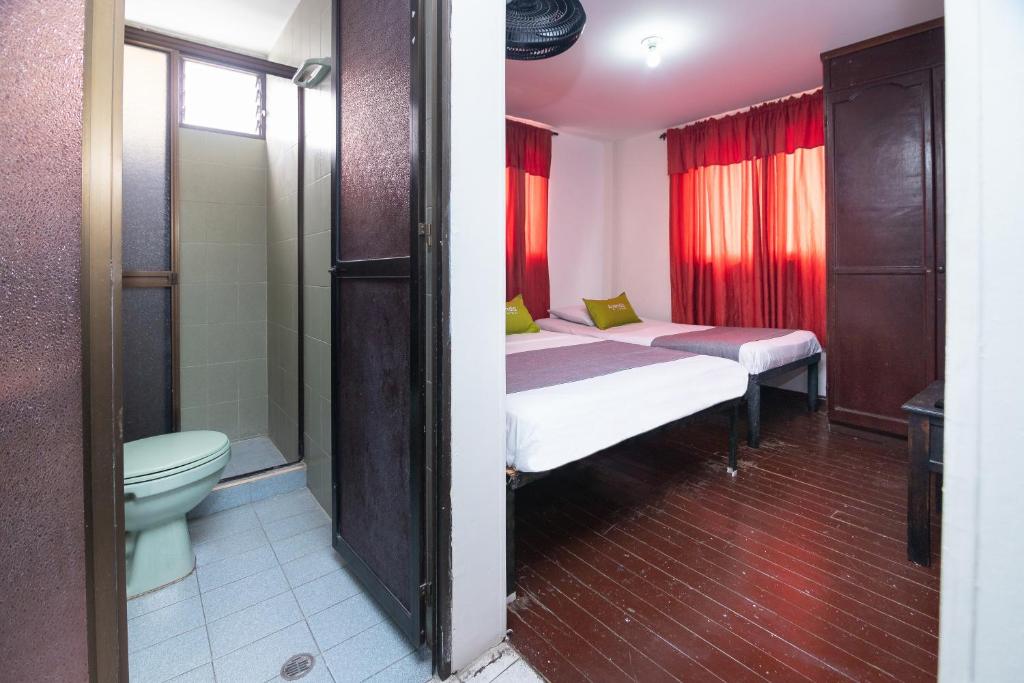 Postel nebo postele na pokoji v ubytování Hotel Ayenda Calypso 1142