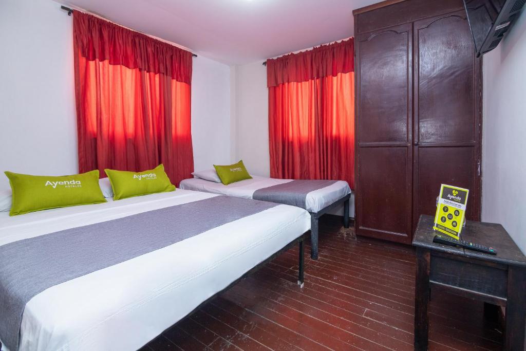 Postel nebo postele na pokoji v ubytování Hotel Ayenda Calypso 1142