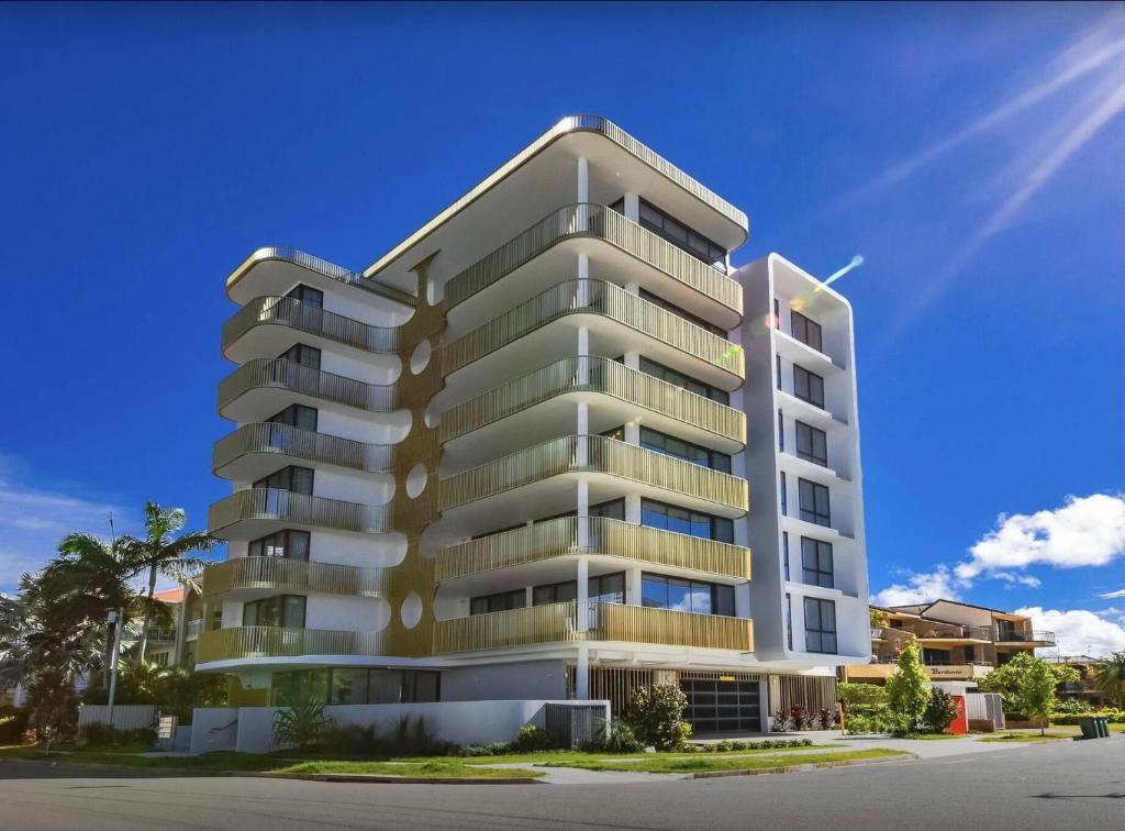 a rendering of a tall apartment building at LOTUS RESORT in Gold Coast