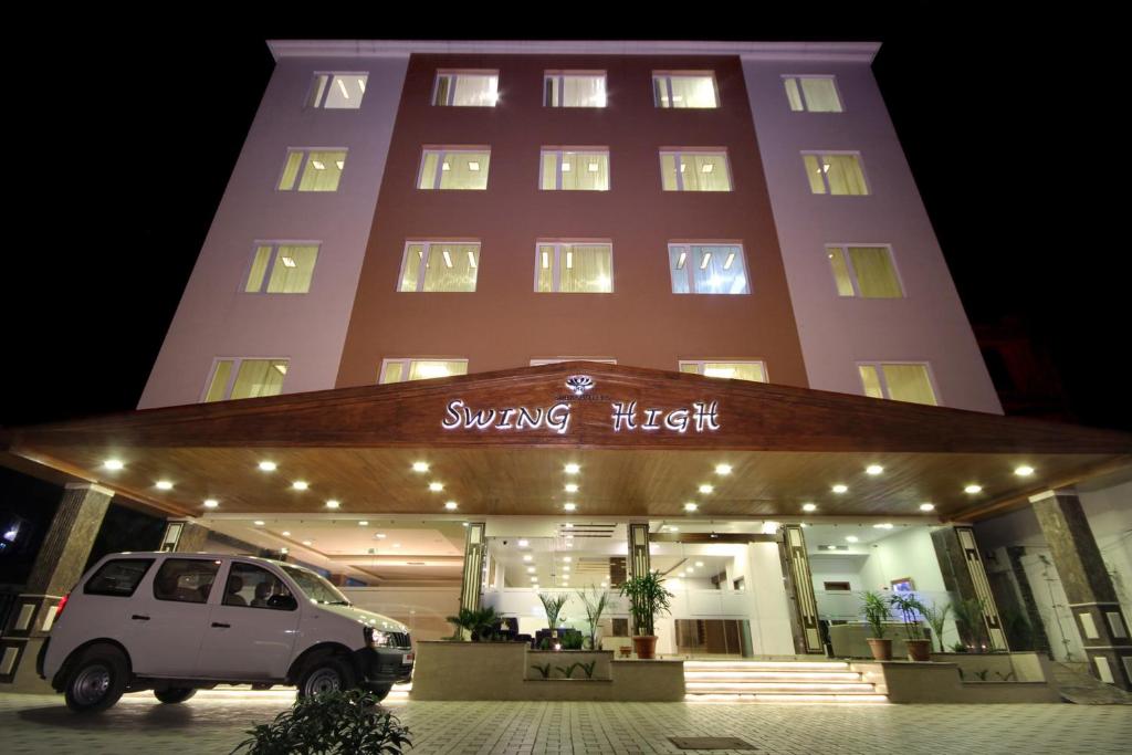 a white van parked in front of a building at Best Western Swing High Katra in Katra