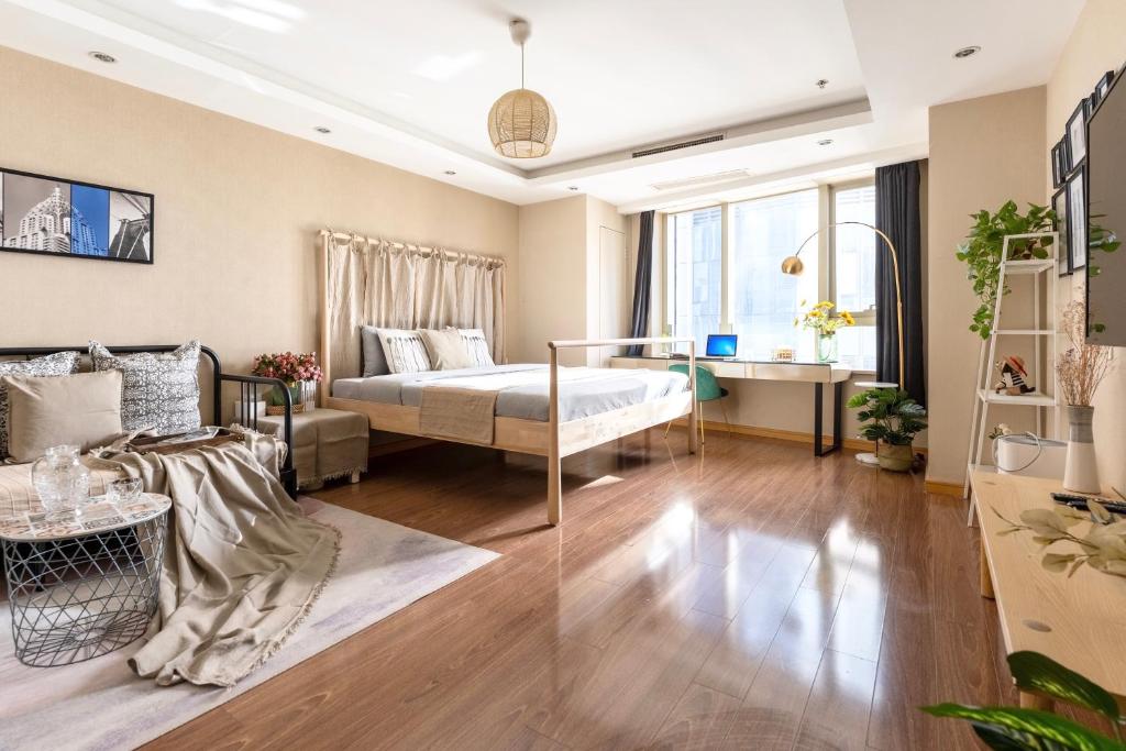 Postel nebo postele na pokoji v ubytování Tianjin G'apartment - Five Great Avenues