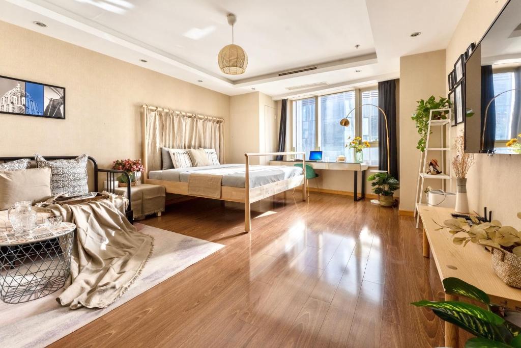 Postel nebo postele na pokoji v ubytování Tianjin G'apartment - Five Great Avenues