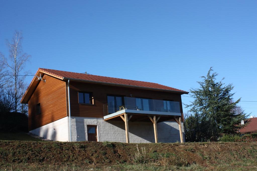 a house with a large window on the side of it at Chalet à L'Orée du Bois in Le Tholy