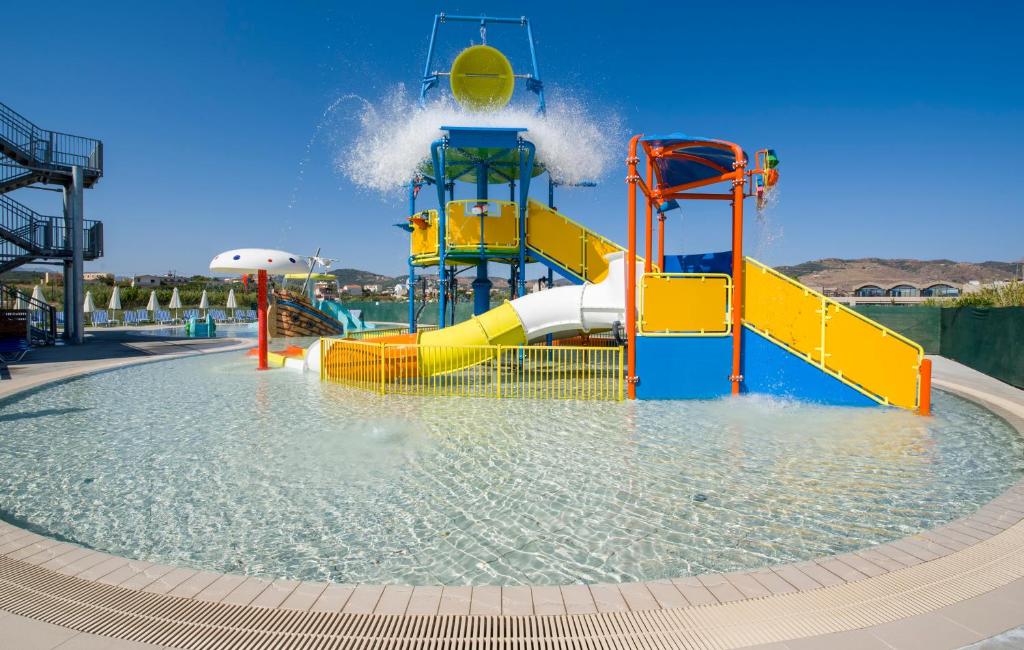 a water park with a slide in the water at Selini Suites & Waterpark in Kolymvari