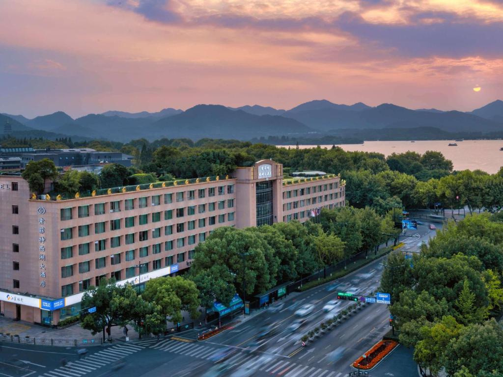 an aerial view of a building and a street with cars at Sofitel Hangzhou Westlake in Hangzhou