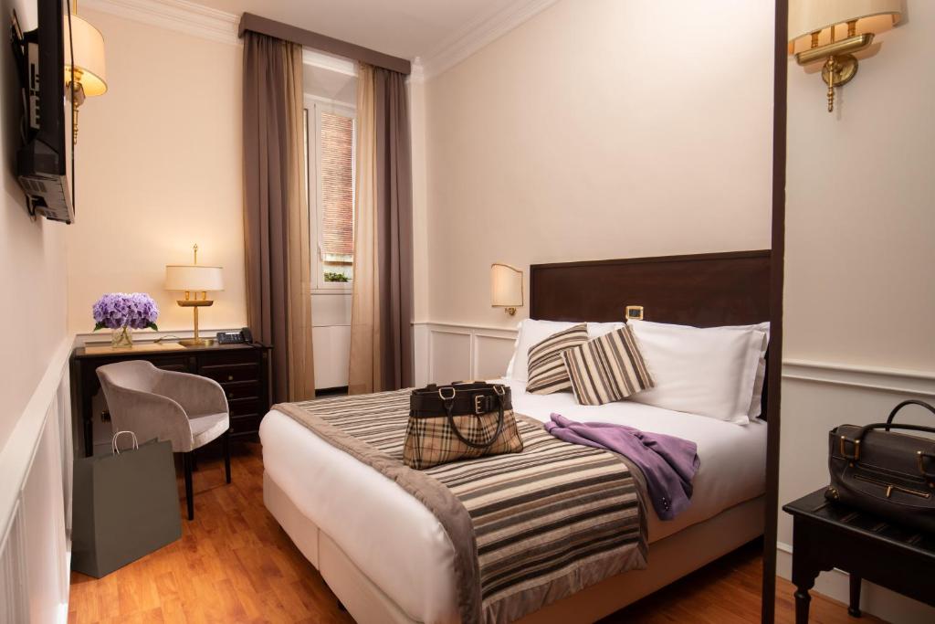 Postel nebo postele na pokoji v ubytování Hotel Del Corso