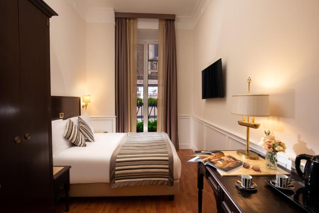 Postel nebo postele na pokoji v ubytování Hotel Del Corso