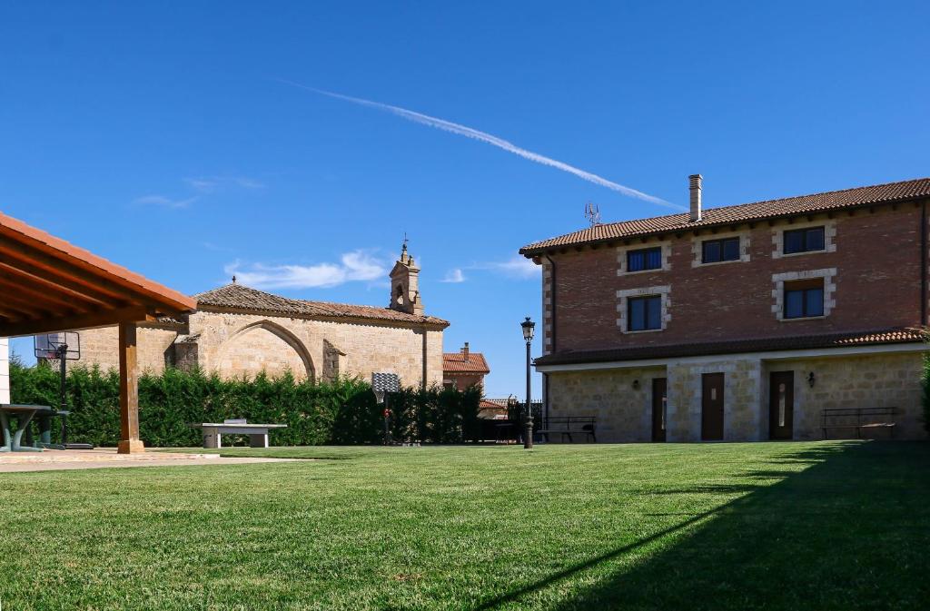 un gran patio con un edificio y una iglesia en Casa rural Ermita 1 y 2, en Burgos