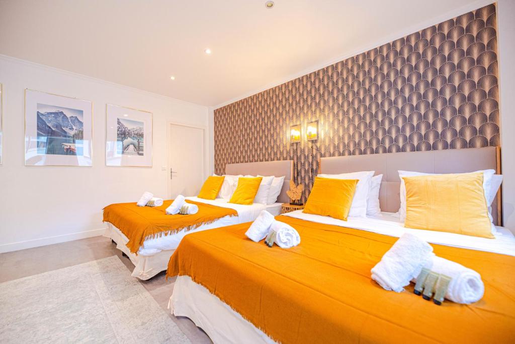 two beds in a room with yellow and white at Luxury flat- Eiffel tower in Paris