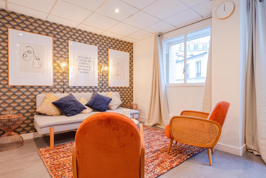 a living room with a couch and chairs and a window at Luxury flat- Eiffel tower in Paris