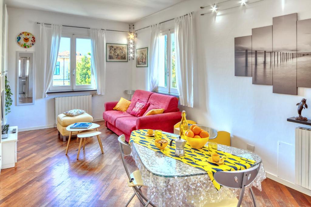 een woonkamer met een rode bank en een tafel bij RAFFAELLA House in Levanto
