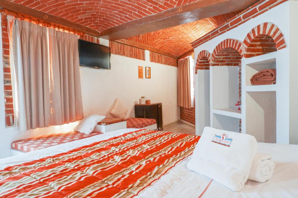 Postel nebo postele na pokoji v ubytování Suites Paraiso Tequis