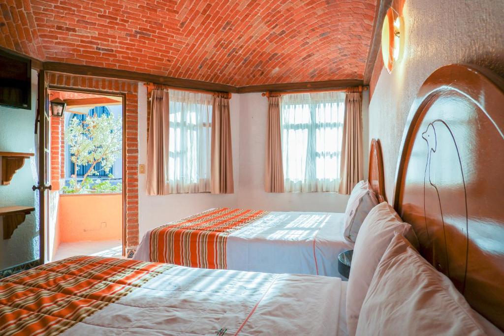 Postel nebo postele na pokoji v ubytování Suites Paraiso Tequis
