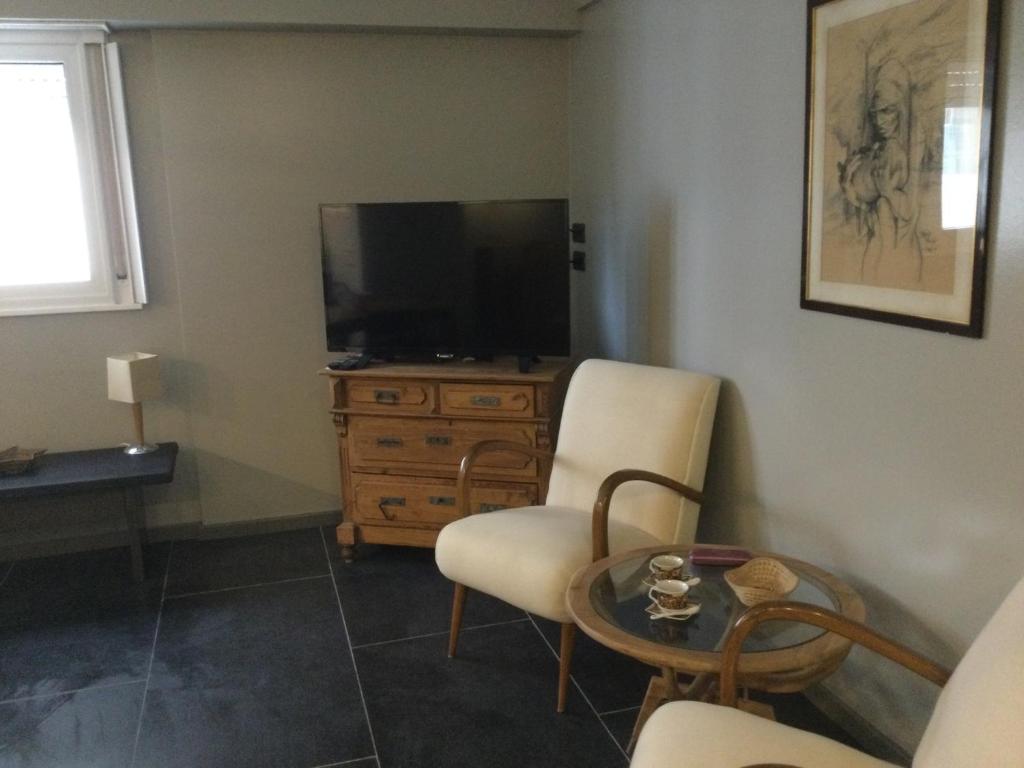 een woonkamer met een tv en 2 stoelen en een tafel bij Bellavista XIV in Mar del Plata