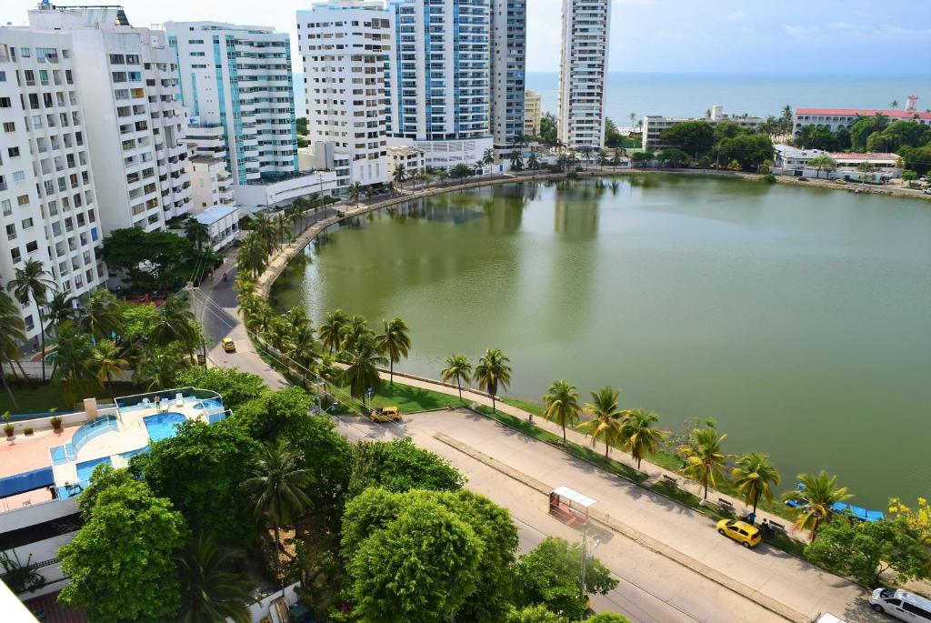 a large body of water with palm trees and buildings at Luis del Mar - Edificio Nuevo Conquistador in Cartagena de Indias