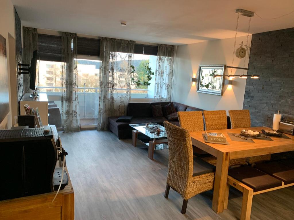 a living room with a table and a couch at Hahnenklee Ferienpark 409 & 211 in Goslar