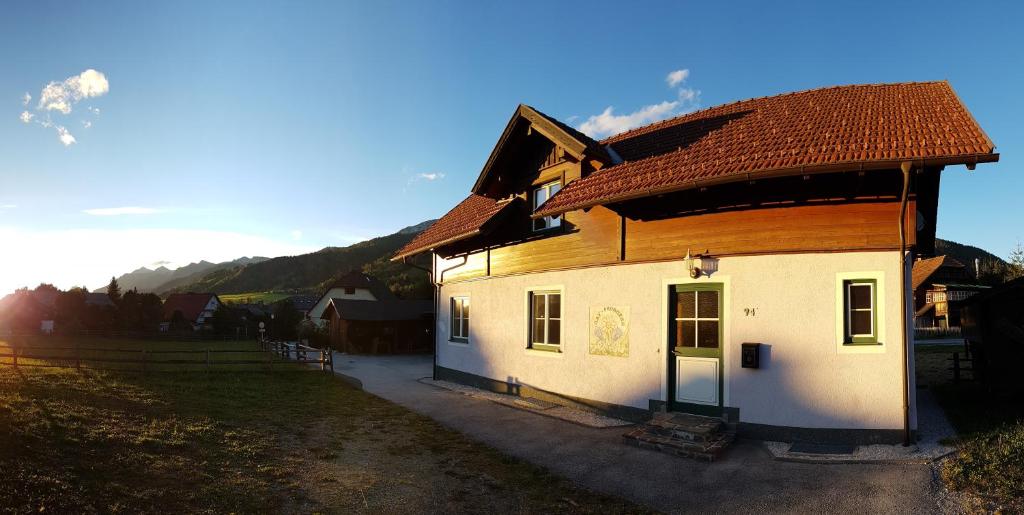 una casa con techo marrón en un campo en Alpenvereinshaus Pruggern, en Pruggern