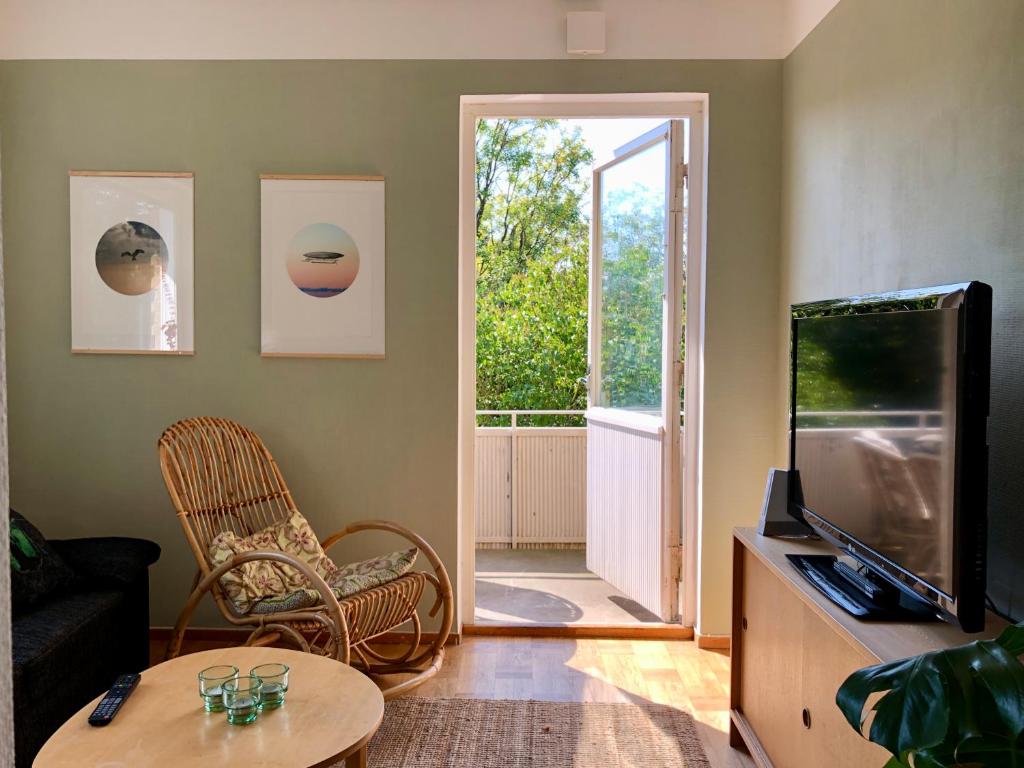 a living room with a tv and a table at HEMMET Simrishamns vandrarhem och B&B in Simrishamn