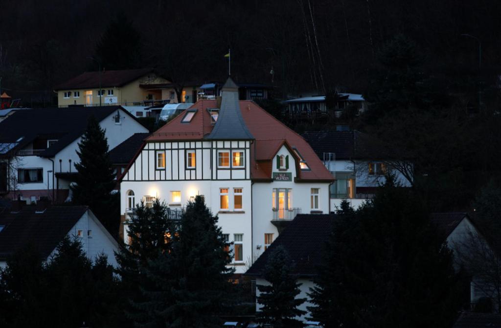 a large white house with a red roof at Villa Waldfrieden - Gästehaus zum Jugendstilhotel in Annweiler am Trifels