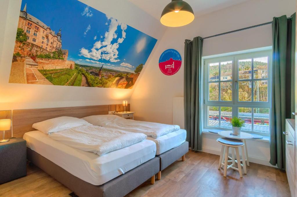 a bedroom with a bed and a large window at Hostel-Marburg-one in Marburg an der Lahn