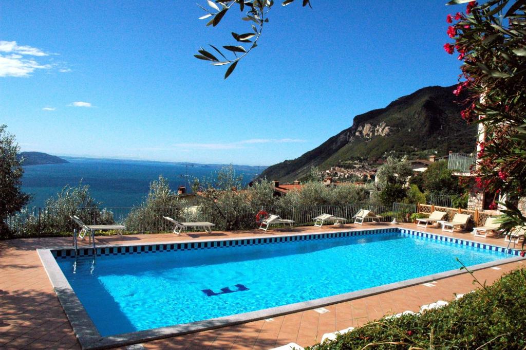 a swimming pool with a view of the ocean at Residence Erika in Tignale