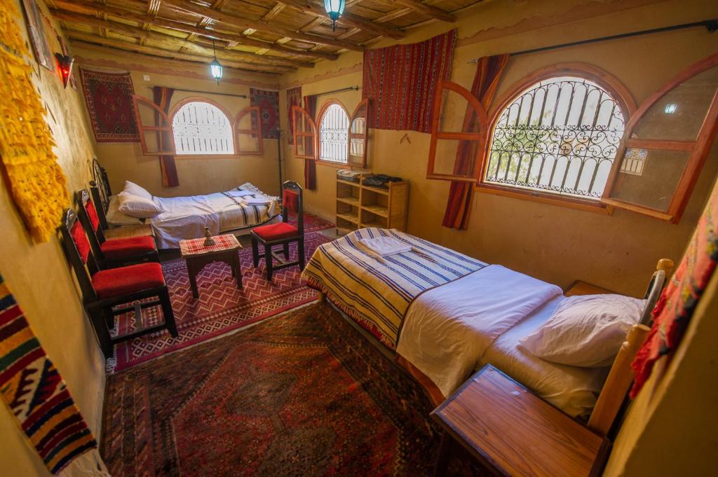 A bed or beds in a room at Dar tiwira