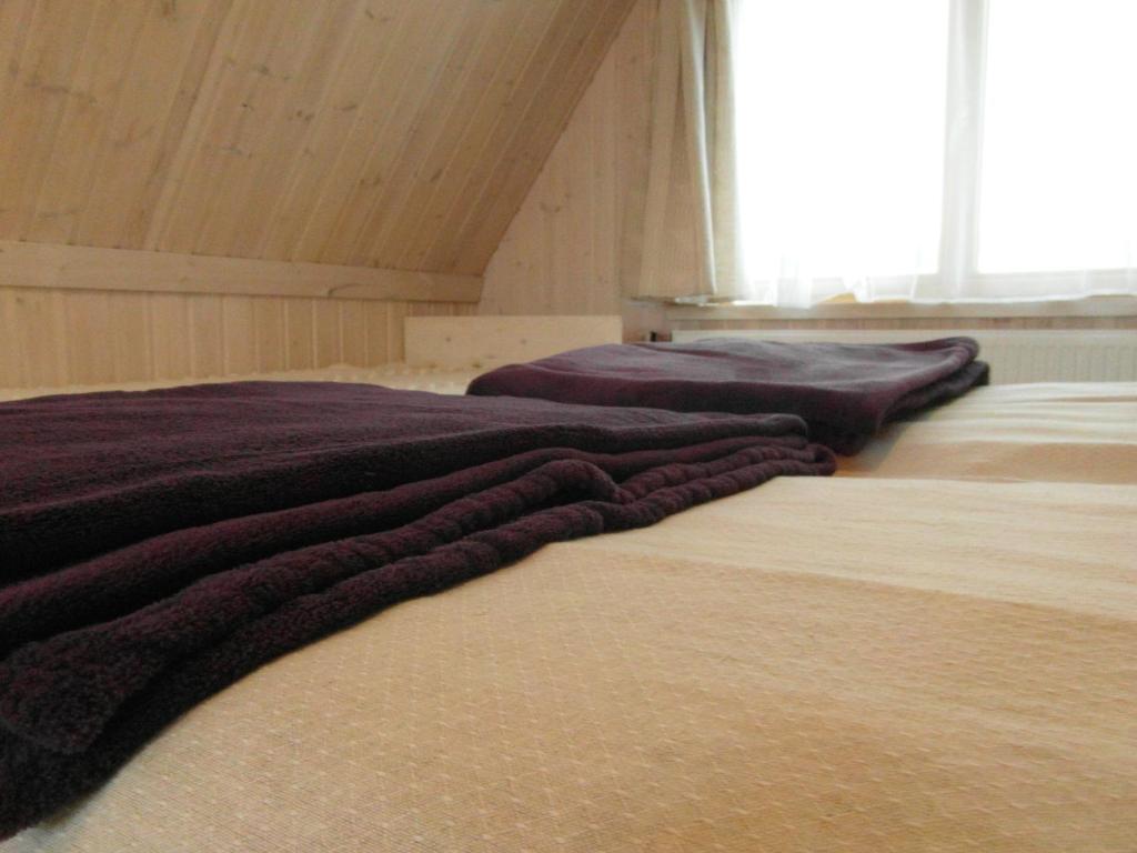 two beds sitting next to each other in a room at White Cottage in Druskininkai