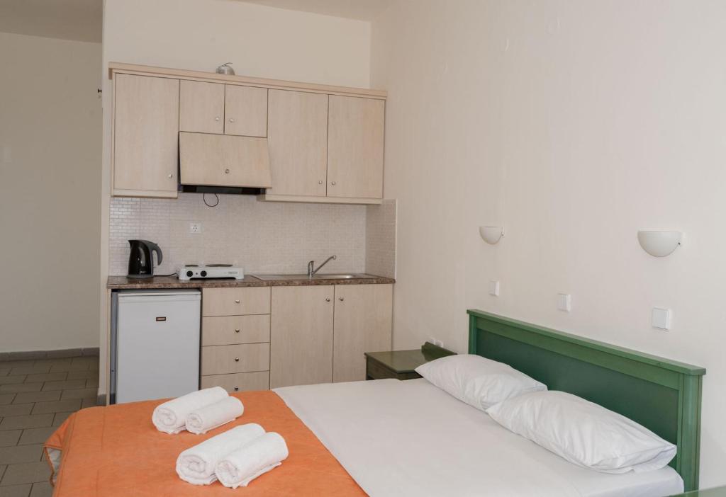 a bedroom with a bed with two towels on it at Aretousa in Sougia
