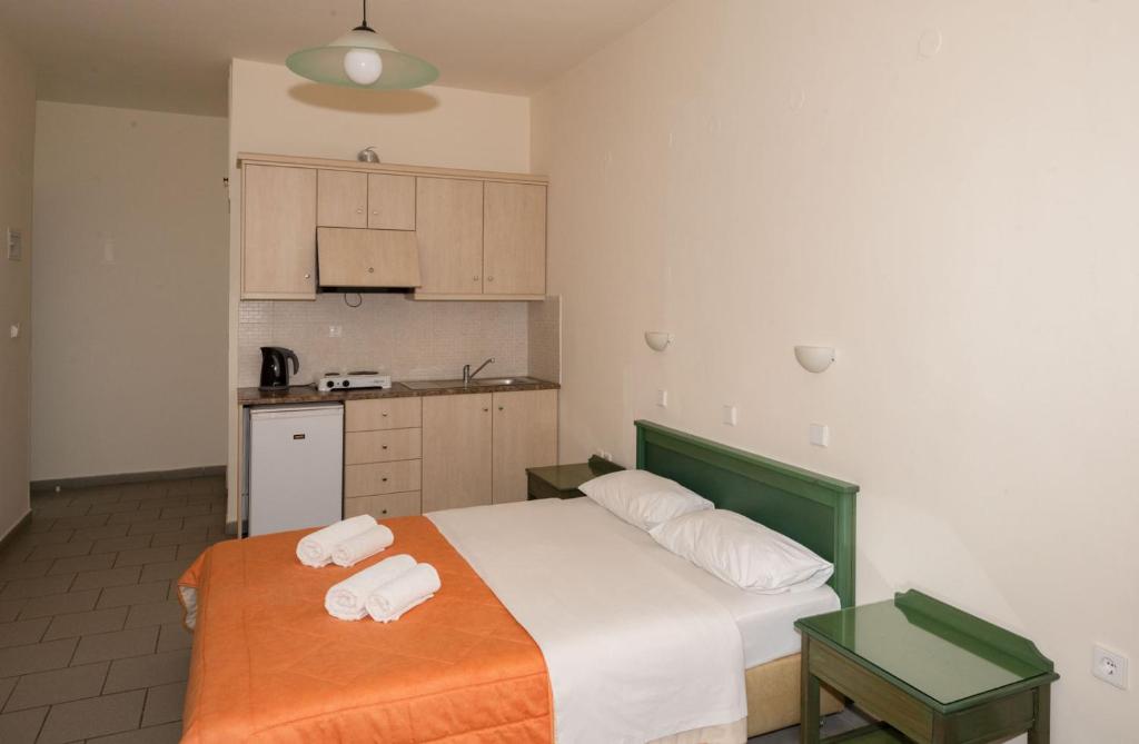 a bedroom with a bed with two towels on it at Aretousa in Sougia