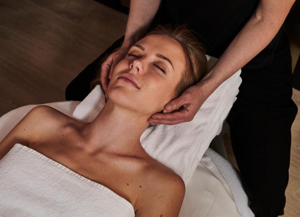 a woman getting her hair washed at a salon at SCHLOSS Zermatt - CBD & Adaptogenic Spa and Sport Hotel in Zermatt