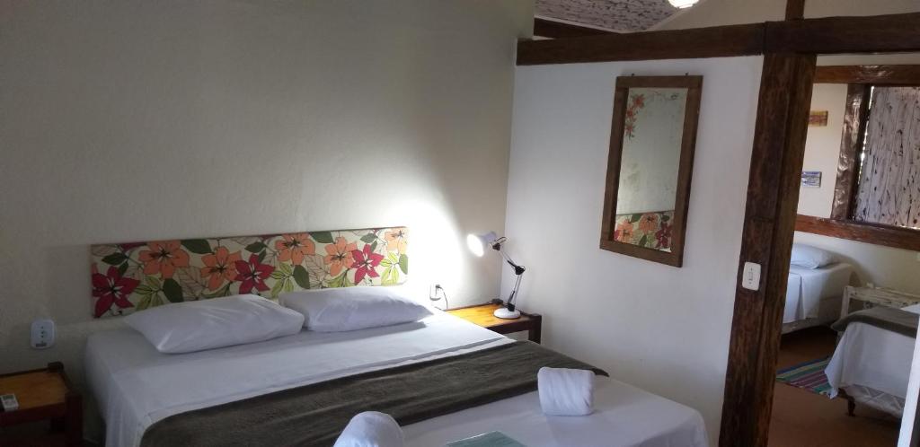 Cama ou camas em um quarto em Pousada Macunaima