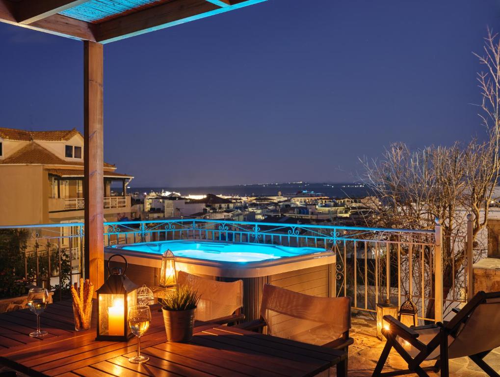 a deck with a hot tub on a balcony at Ninemia Villa Zakinthos in Zakynthos Town