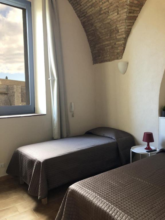 Łóżko lub łóżka w pokoju w obiekcie Dimora Sole Raggiante