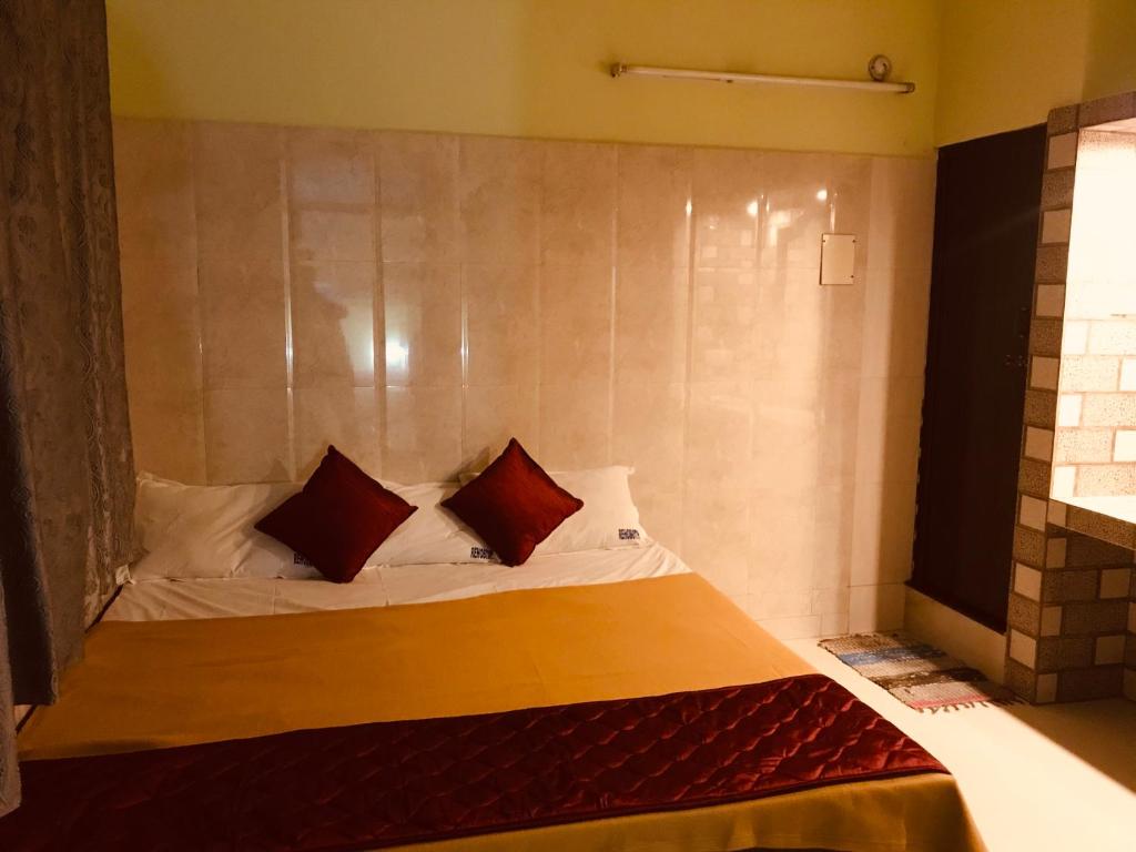 a bed with two pillows on it in a room at Rehoboth Home Stay in Kanyakumari