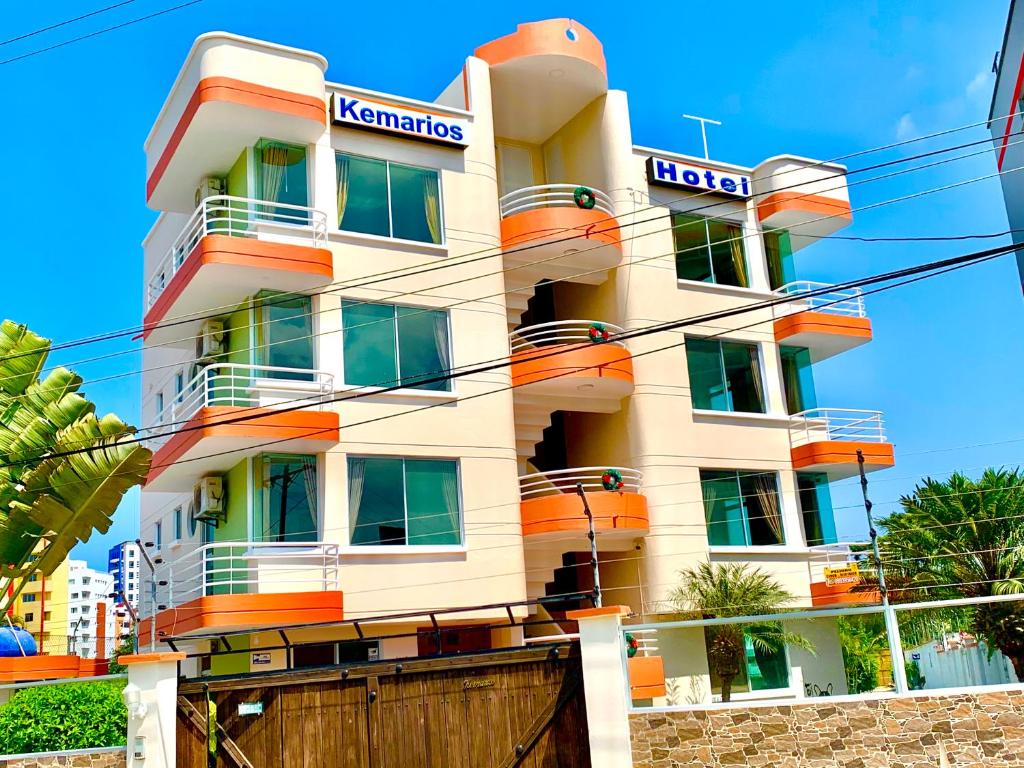 a building with an orange and white at Hotel Kemarios in Tonsupa