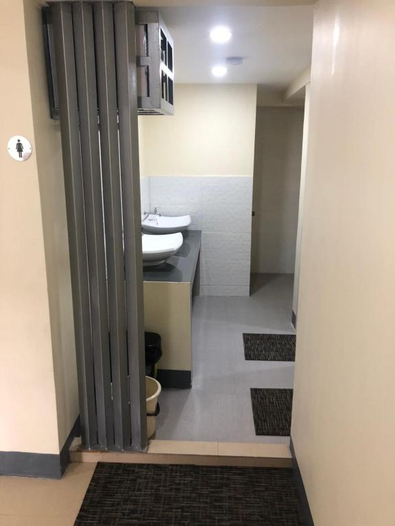 a bathroom with a sink and a toilet in a room at Snoozeph in Manila