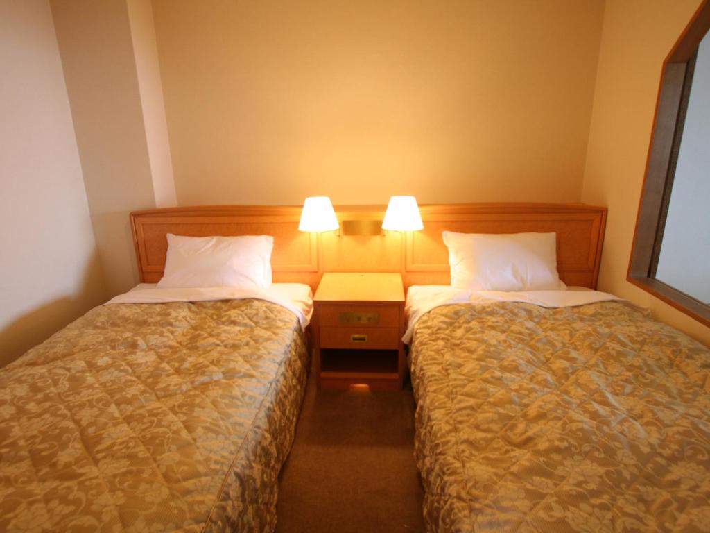 Postel nebo postele na pokoji v ubytování Hotel Nankaiso